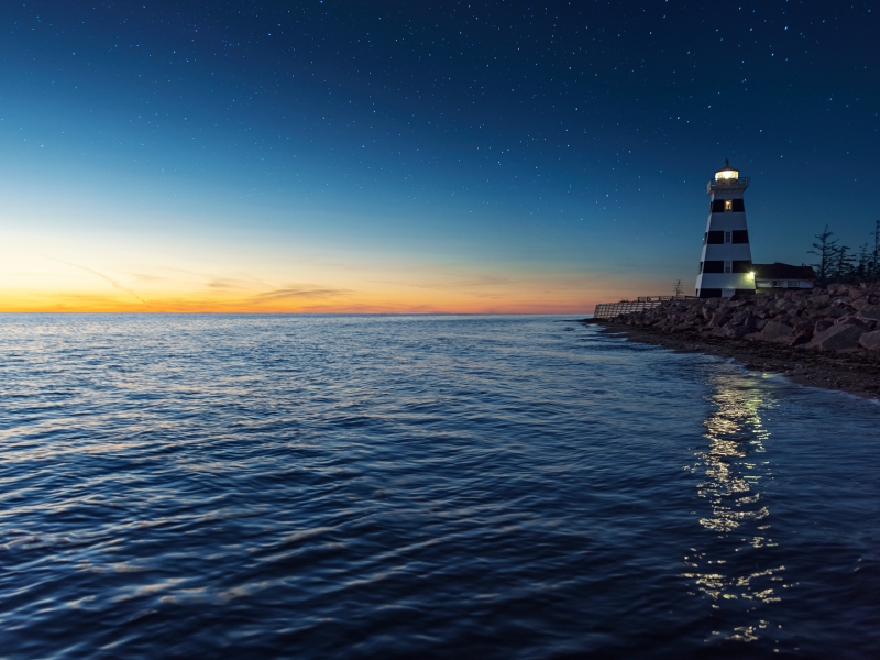 West Point Lighthouse under a starry sky