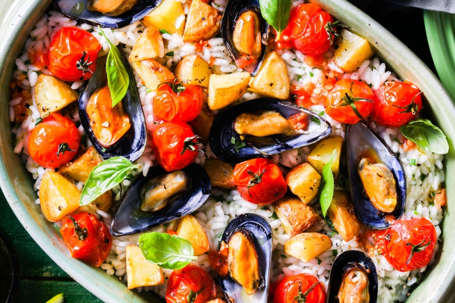 Culinary PEI One dish meal of rice, steamed mussels, cherry tomatoes and potatoes in a cream sauce